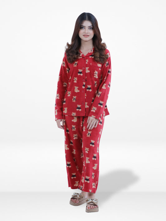 Woman wearing a red pajama set with a pattern on a white background