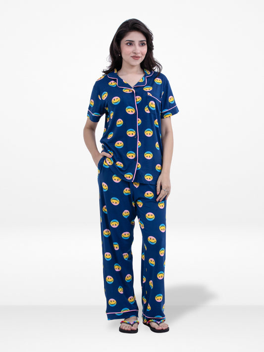 Woman wearing a navy blue pajama set with a pattern on a white background