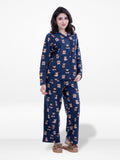 Woman wearing a navy blue pajama set with a pattern on a white background