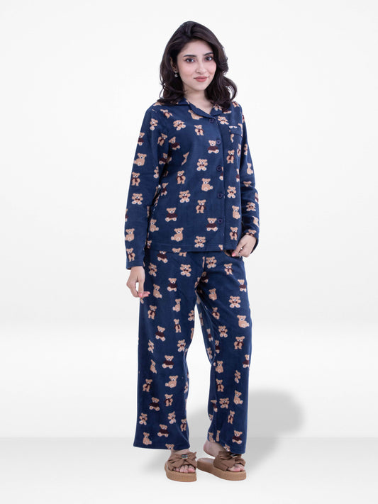 Woman wearing a navy blue pajama set with a pattern on a white background