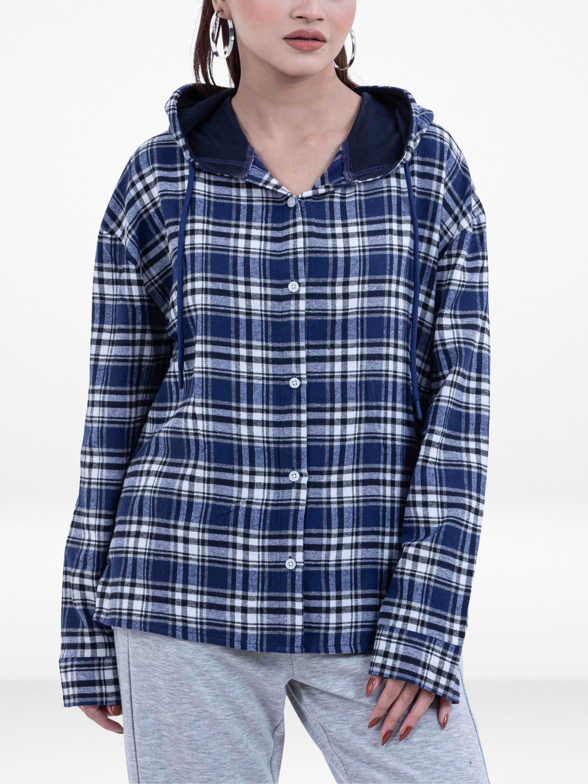Person wearing a blue and white plaid shirt with a hood on a white background