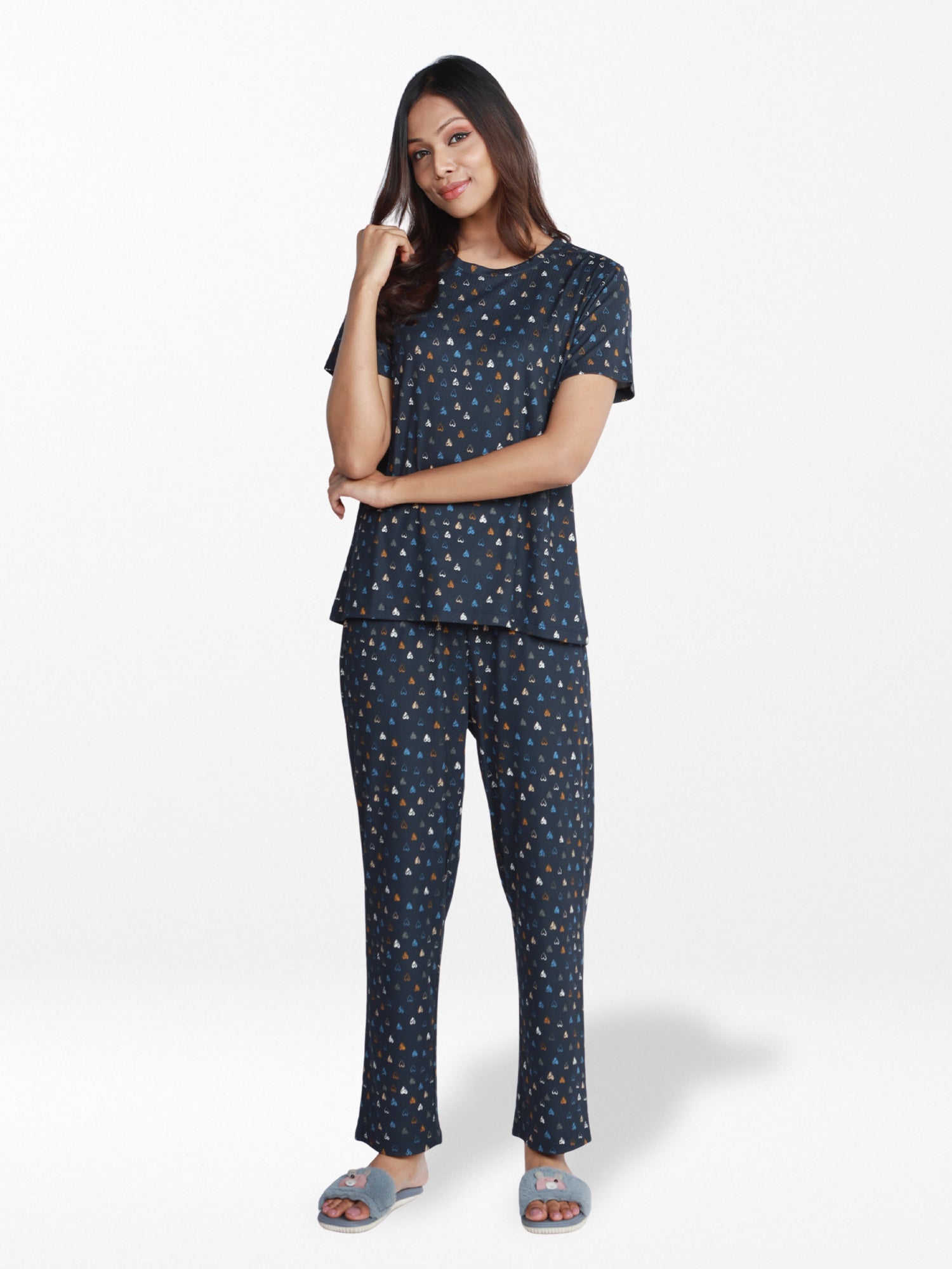Woman wearing a navy blue pajama set with a subtle pattern on a white background