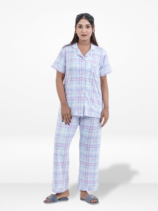Woman wearing a checkered pajama set on a white background