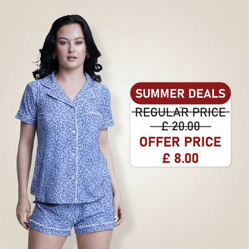 Woman wearing a blue patterned outfit with a 'Summer Deals' sign indicating a price reduction.